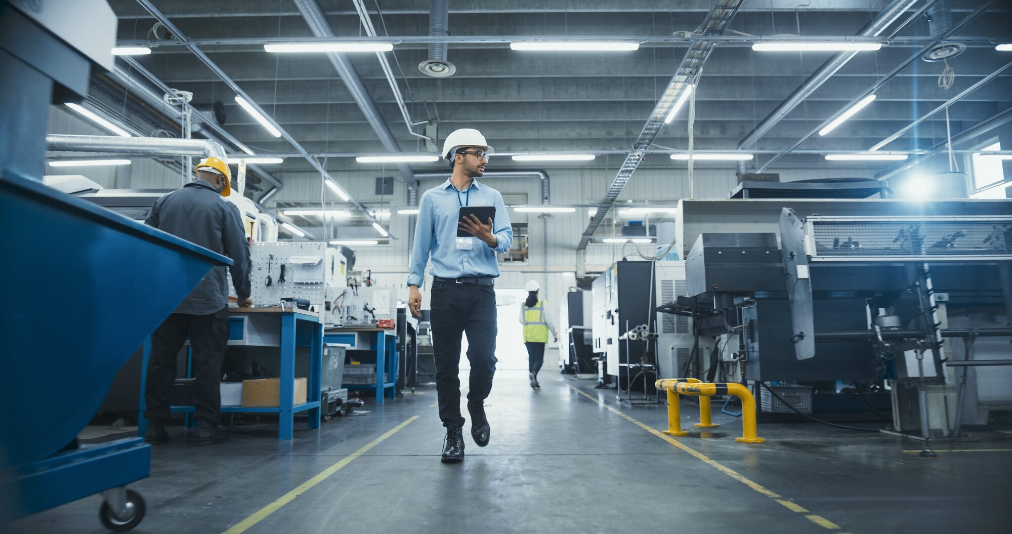 Engineer walking the factory floor with a tablet