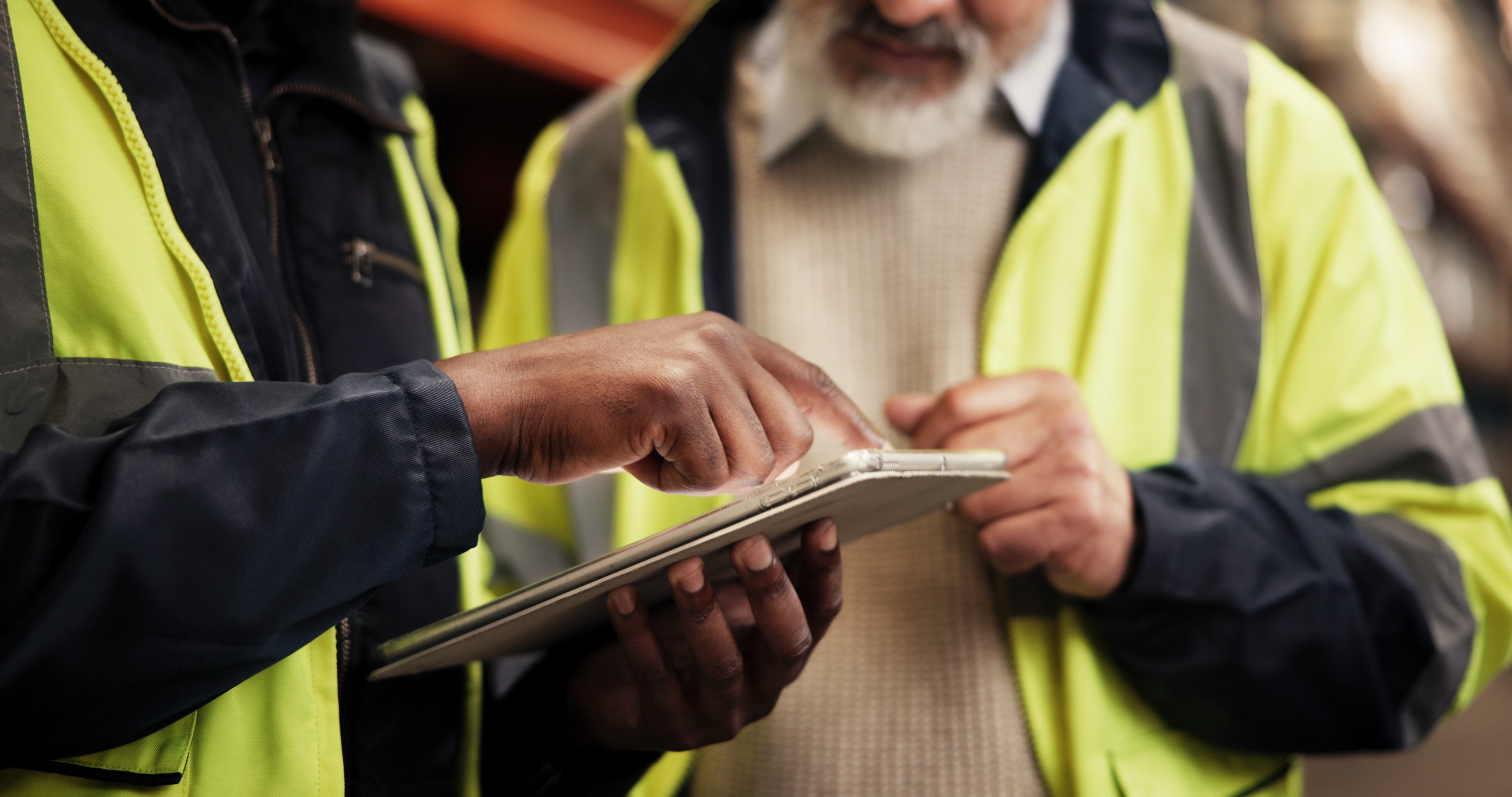 Engineers reviewing a job on a tablet on the shop floor