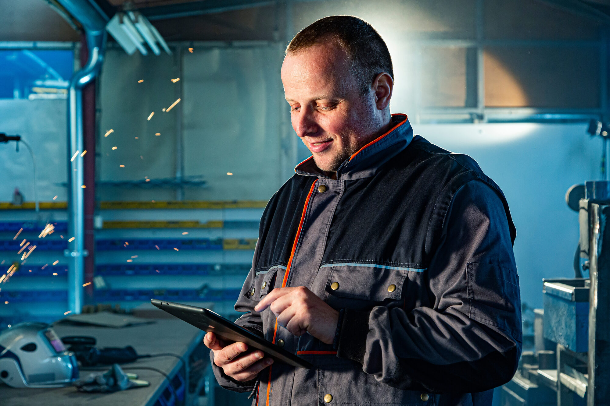 Fabricator reviewing a job on a tablet in the workshop